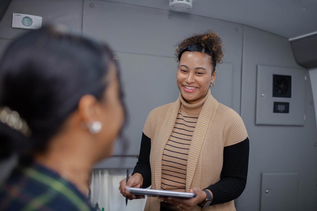 community health worker, Scarlet Pujols Recio, who speaks both English and Spanish, helps to connect patients