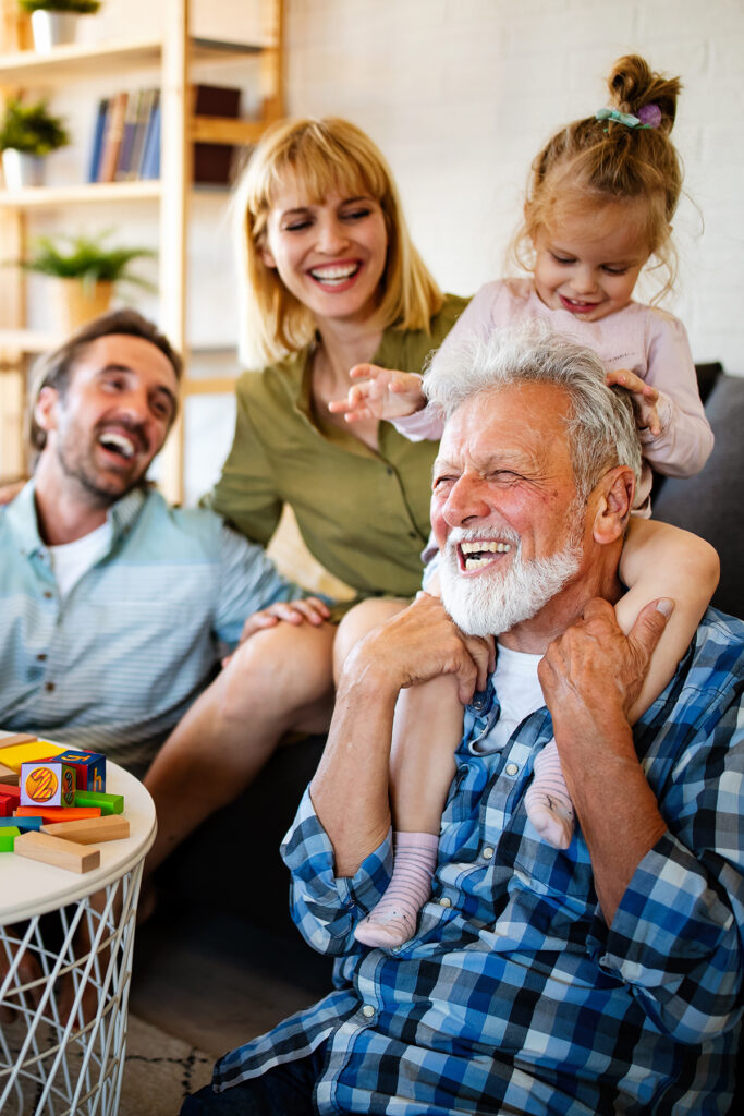 Senior grandparents playing with grandchildren and having fun with family