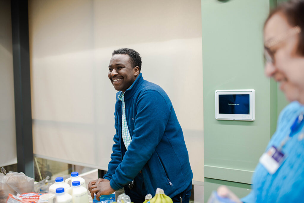 Wail Alsafi volunteers with The Wright Center for Patient & Community Engagement to pack bags of healthy food for distribution to those in need in the regional community